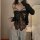 Woman modeling pure & tempting lace lingerie set - sheer black bodysuit with bow, paired with cozy grey sweatpants and a knit...