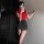 A woman poses confidently wearing a red top and black mini skirt, embodying elegance and allure. the outfit features a seduct...