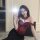 A woman poses with a mirror, wearing a red lace push-up corset vest set paired with black bottoms. the design features sheer ...