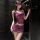 Woman in purple lace-trimmed camisole and open-crotch bodycon skirt from pure & tempting lingerie set, posing by dark doorway...