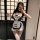 Woman wearing pure & tempting lingerie set – a white and navy maid-style outfit with apron, bow tie, garters, and lace stocki...