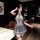 A woman poses confidently wearing a stylish gray pure & tempting lingerie set, featuring a sexy lace sleep dress with a tie d...