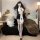 Woman modeling pure & tempting lingerie set: sheer cut-out bust, bodycon mini skirt, nun-themed cosplay with cross details.