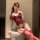 Woman in red lace lingerie set with matching thigh-highs, featuring a seductive design and no-remove style for small busts.