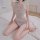 Woman wearing light blue sheer mesh lace bodysuit with open-crotch and tear-away design, kneeling on bed.