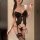 Sexy black lace bodysuit with integrated bra design, featuring push-up pads and garter straps for a glamorous look.