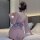 A woman sits on a bed wearing a purple lace sleepwear inspired by hanfu, featuring an off-shoulder design and a large bow at ...