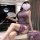 A woman elegantly poses wearing a purple chinese-inspired lace cheongsam dress with hook-neck design and vintage buttons. the...