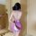 A woman stands facing away from the camera, wearing a purple deep v cheongsam lingerie set made of seductive silk-like fabric...