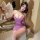 A woman poses elegantly in a purple deep v cheongsam lingerie set, featuring a sheer silk-like dress with floral accents, per...