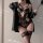 Woman wearing purple lace bodysuit with sheer panels and floral detailing, styled seductively with thigh-highs and a draped j...