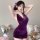 Woman wearing purple lace bodysuit skirt set, seductive no-remove lingerie sleepwear outfit with floral hair accessory.
