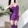 Woman wearing purple lace bodysuit with thong design, featuring seamless fit and busty look, paired with matching stockings.