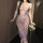A woman wears a purple lace sleepwear dress inspired by traditional chinese attire, featuring delicate floral patterns and of...