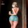 Woman in purple lace sleep dress, back view, holding phone, playful nightwear for small bust.
