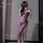 Woman wearing purple lace lingerie set with sheer strap nightdress, high slit, and uniform-inspired design.