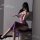 Woman wearing purple lace lingerie set with sheer straps, high slit, and uniform-inspired design, posing in mirror selfie.