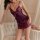 Woman modeling purple lace sheer sleepwear set with cami top and shorts, featuring delicate bows and elegant design for sexy ...