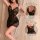 Woman modeling purple lace sheer sleepwear set with cami top and shorts, featuring delicate floral patterns and elegant desig...