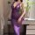A woman wears a purple sheer lace nightgown with a plunging neckline, adorned with delicate bows. the elegant design features...