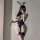 Woman wearing purple lace bodysuit with bunny ears, holding a wand—sexy lingerie set for alluring sleepwear or costume.
