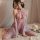 A woman poses elegantly in a purple sheer lingerie set, featuring an open-crotch design and matching bralette and panty. the ...