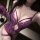 Woman wearing purple lace bodysuit with open-crotch design, matching gloves and thigh garter, showcasing sensual lingerie out...