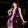 A woman poses elegantly in a luxurious purple sensual hanfu lingerie set, featuring a deep v-neckline and floral accents, per...