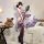 A woman poses elegantly in a purple sensual lingerie set featuring a modest-chic design with sheer mesh and ties, no-remove s...