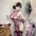 A woman poses elegantly in a purple sensual lingerie set featuring a modest-chic split qipao design with sheer mesh and ties,...