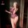 Woman in mirror selfie wearing purple sensual lingerie set with open-crotch design and lace trim, easy-wear uniform style nig...