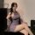 A woman poses elegantly in a purple sheer chinese-inspired lingerie set, featuring a delicate lace design and stylish cutouts...