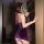 A woman models a purple silk-look sensual hanfu lingerie set, featuring a sexy modest qipao design with a push-up bra and mat...