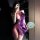 A woman poses with a smartphone, wearing a purple silk-look sensual hanfu lingerie set. the outfit features a deep v-neckline...