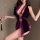 Woman wearing a purple velvet qipao lingerie set with deep v-neck and floral details, featuring a tie-back design for a seduc...