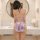 A woman stands facing away from the camera, wearing a purple vintage floral cheongsam lingerie set. the backless design featu...