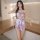 A woman poses in a purple vintage floral cheongsam lingerie set featuring a backless design, hollow-out cutouts, and an open-...