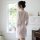 A woman stands facing away from the camera, wearing a sheer mesh lace sleeve robe set. the ensemble features delicate lace de...