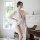 A woman poses elegantly in a sheer white robe set featuring lace sleeves, perfect for intimate sleepwear and lounge wear.