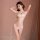 Woman modeling qiao hu niang white lace lingerie set with sheer bra and open-crotch panty, hands behind head.