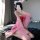 A woman poses with cat ears, wearing a pink qiaoduo hanfu-inspired bodysuit and skirt, embodying a fox spirit design. the set...