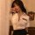 Woman in qiaozhiqing sexy air hostess costume set, featuring a white button-up shirt with police patch and black skirt.