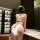Woman wearing qiaozi leopard print lingerie set, featuring a strapless bra and thong, in a modern room setting.