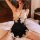 Woman wearing black and lace qing lian yi sexy lace sleep dress, backless strap nightgown, sitting on bed in seductive lounge...