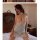 Woman wearing qing lian yi sexy lace sleep dress - backless strap nightgown with delicate lace detailing, seated on bed in el...
