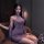 A woman elegantly poses wearing a purple qing ran sensual off-shoulder cheongsam, featuring lace detailing and frog buttons. ...