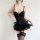 Woman modeling black sheer lace bodysuit with push-up bra, ruffled skirt and matching thigh-high stockings.