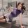 A woman poses elegantly in a luxurious bathroom, wearing a stylish purple bodycon mini skirt paired with matching sleep dress...