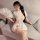 A woman elegantly poses on a couch wearing a qingran new chinese style cheongsam dress. the dress features lace detailing, as...
