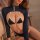 Woman wearing navy qingran cut-out thong bodysuit with sheer bust detail and open-crotch design.